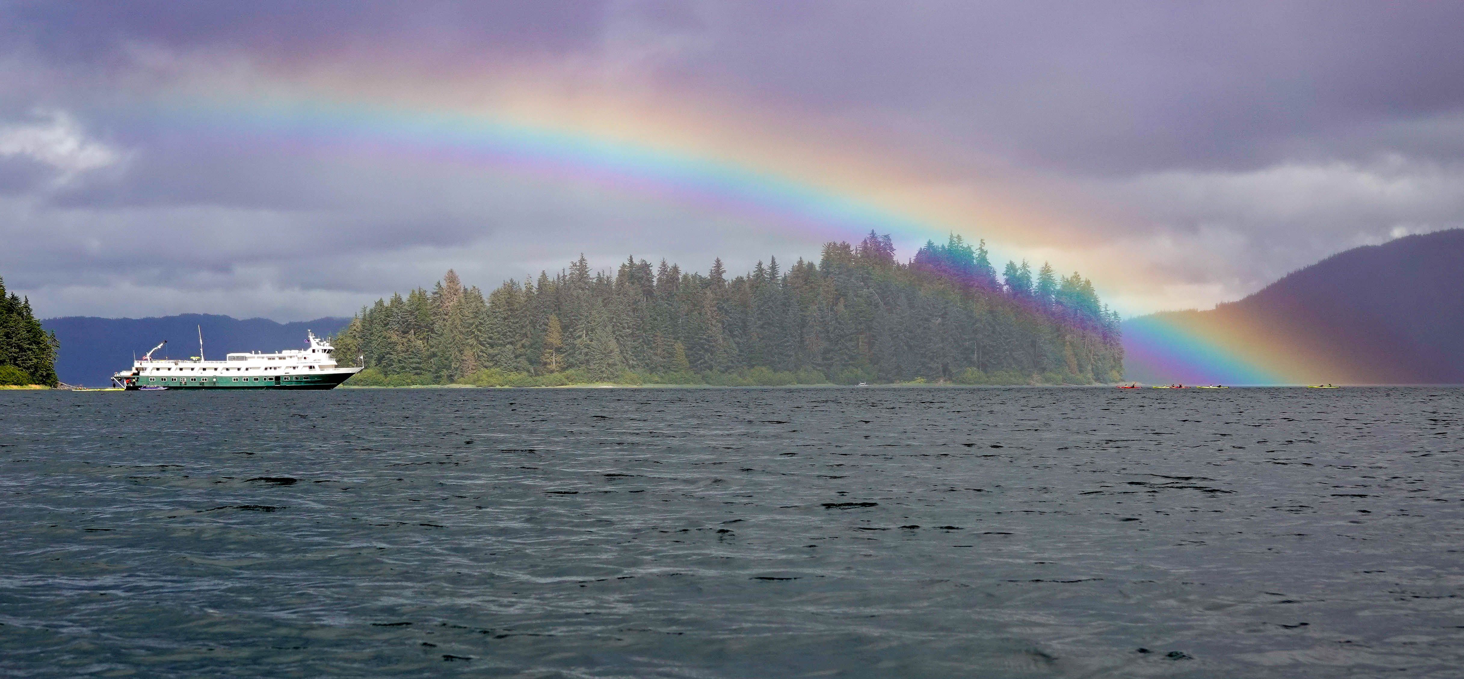 Wilderness Discoverer with a rainbow and kayakers